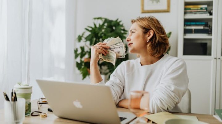 A happy freelancer showing money